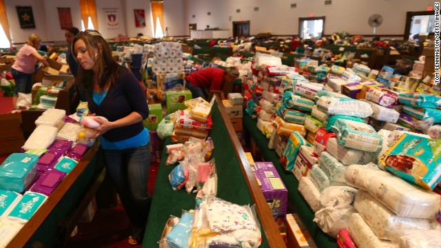 Volunteer Brittany Pendergraft organizes donated tornado relief items inside the Yellow Rose Theater on May 25 in Moore.