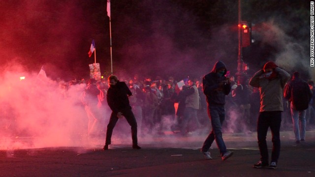 Protesters stand in the street as they face riot police on Sunday, May 26, in Paris on the sidelines of demonstrations against a gay marriage law legalizing same-sex marriage and adoptions for gay couples. President Francois Hollande s<a href='http://www.cnn.com/2013/05/18/world/europe/france-same-sex-marriage/index.html'>igned the measure into law</a> on May 18 following months of bitter debate and demonstrations, including <a href='http://www.cnn.com/2013/05/21/world/europe/france-cathedral-death/index.html'>a suicide </a>at Notre Dame Cathedral in the name of protesting same-sex marriage.