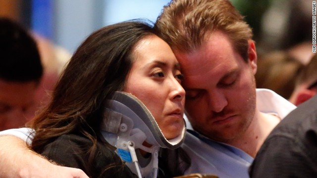 Plaza Towers Elementary School teacher Jennifer Doan is comforted by her fiance, Nyle Rogers, on May 26. 