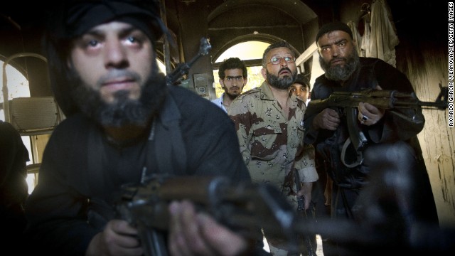 Syrian rebels take position in a house during clashes with regime forces in the old city of Aleppo on May 22.