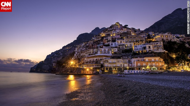 The Italian village of <a href='http://ireport.cnn.com/docs/DOC-921855'>Positano</a> spills from the cliffs onto the beach. Christopher Foltz, who shot this photo, said it's his favorite town in the whole country.