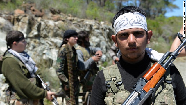 Rebel fighters from the Al-Ezz bin Abdul Salam Brigade train near the al-Turkman mountains in Syria.