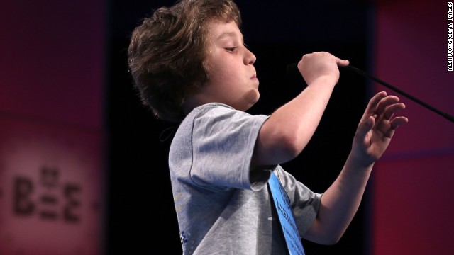 Alexander Schembra of Lillington, North Carolina, lowers the microphone before attempting, and failing, to spell "Beethovenian" during round three on May 29. Beethovenian is an adjective used to describe things that are related to or characteristic of Ludwig van Beethoven, his works or musical style. 
