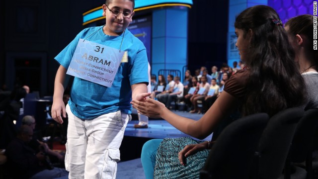  Abram Mikhaeel Goda, left, of Bridgeport, Connecticut, hi-fives Himanvi Kopuri of Denver, Colorado, after he spells "nomenclative," of or relating to name or the act of naming, in round three on May 29.