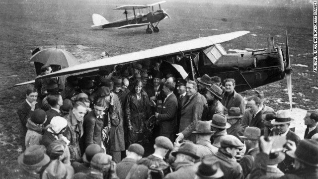 A crowd surrounds Earhart, center, upon arrival at Hanworth airfield in London after she crossed the Atlantic Ocean in 1932.