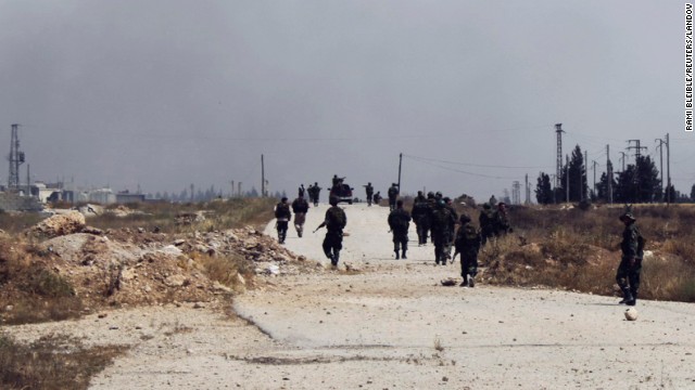Troops supporting the country's president travel in Qusair on May 30.