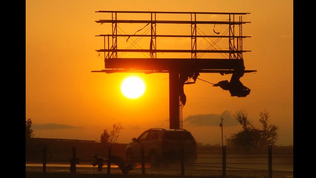 Tornado debris hangs from a billboard sign, which was destroyed along Interstate-40 near El Reno on May 31.