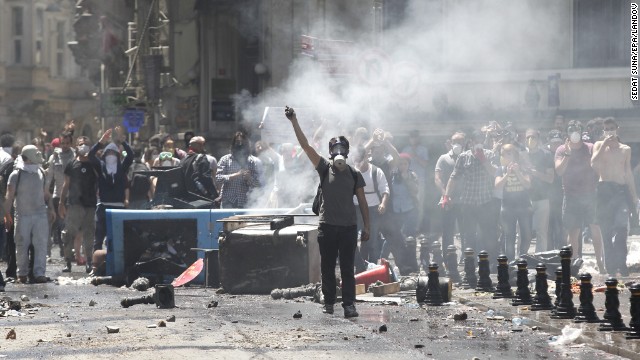 Turkish protesters wearing gas masks face off against riot police near Istanbul's Taksim Square on June 1. 