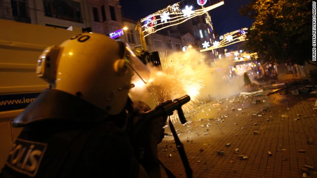 Riot police fire tear gas into the crowd of protesters overnight on Friday, May 31.