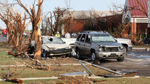 Destroyed trees and cars stand along a road at the Canadian Valley Technology Center in El Reno on June 1.