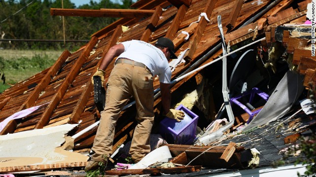 A man searches through the rubble of a home in El Reno on June 1. A large part of Moore, Oklahoma, was without power, as were parts of El Reno and Union City.