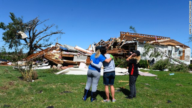 Kim Vanaken, left, consoles her sister Angela Coble, center, along with Amber Kelley while looking at what is left of Coble's house in El Reno on Saturday, June 1. 