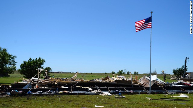 An American flag flies above the destroyed remains of a mobile home in El Reno on June 1.