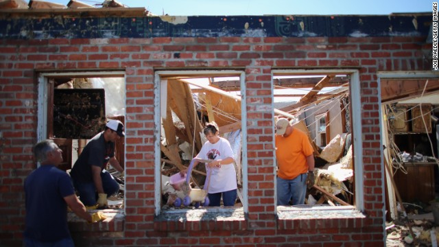 Dustin Horn, second from left, helps his parents, JoAnn and Fred Horn, salvage items from their home on June 2, two days after a tornado ripped through El Reno, Oklahoma. 