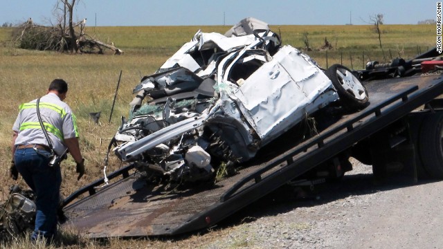 Crews haul away a mangled truck on Sunday, June 2, that storm chasers Tim Samaras, his son Paul Samaras and Carl Young were using to track the tornado that hit El Reno, Oklahoma. The three men, who had devoted their lives to hunting powerful storms died in the middle of the chase. Seventeen tornadoes were reported in the Oklahoma City and St. Louis areas on Friday, May 31.