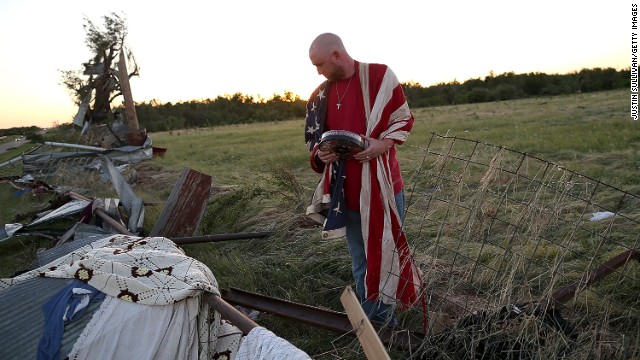 Mark Reynolds sifts through debris to salvage personal items in El Reno on Saturday, June 1.