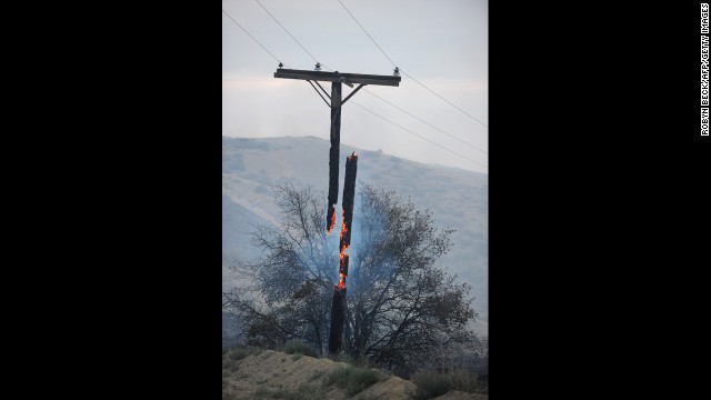 An electrical line pole burns in two pieces after the wildfire ripped through the area overnight in Lake Hughes on June 2.