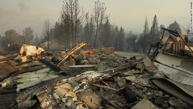 The ruins of a house destroyed in the Powerhouse Fire smolder on June 2 near Lake Hughes.