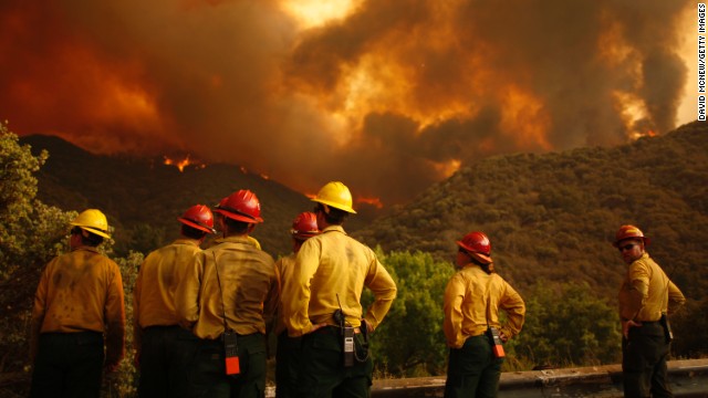 Firefighters watch as the Powerhouse Fire bears down on them as it approaches Lake Hughes on June 1.