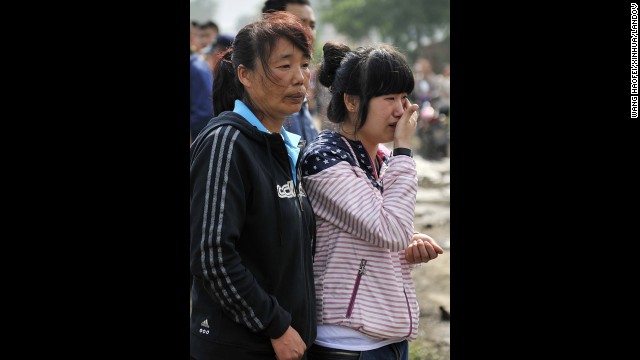 Two women wait for news about a family member. It took six hours to bring the fire under control.