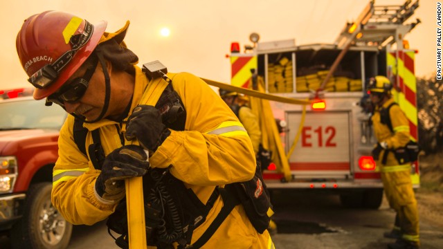 Firefighters move equipment to battle a fire in Lancaster, California, on June 2.