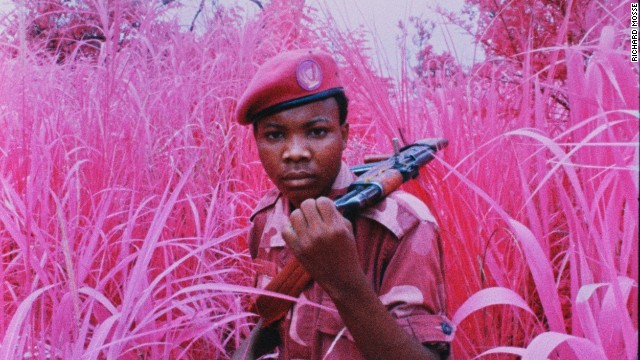 A young soldier from the Mai Mai Yakutumba militia group poses at a secret location near Lake Tanganyika, South Kivu, Eastern Congo, 2012.