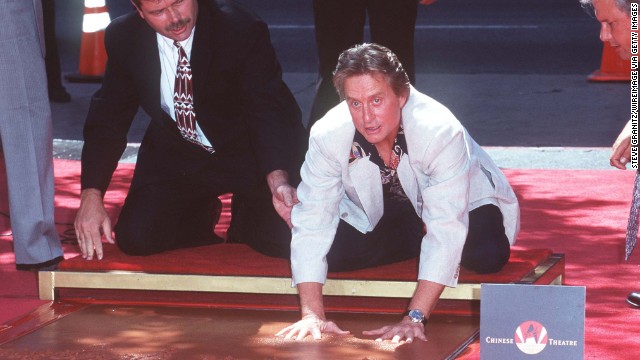 In 1997, the famed actor adds his handprints and footprints to the Hollywood Walk of Fame in California.