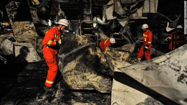 Firefighters work at the accident site. A Xinhua news agency report says the plant's complicated interior structure and narrow exits have made the rescue work difficult. 