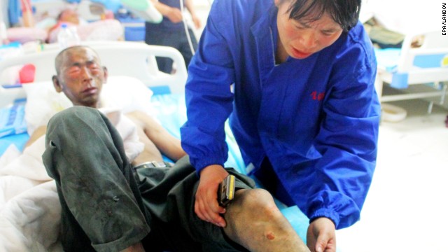 A nurse provides medical treatment to an injured worker who escaped the poultry plant.