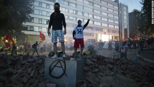 Protesters stand atop a pile of rubble during clashes with Turkish police outside of Prime Minister Recep Tayyip Erdogan's office, near Taksim Square in Istanbul, on Monday, June 3. The protests began as a <a href='http://www.cnn.com/2013/06/03/world/europe/turkey-conflict-explainer/index.html'>demonstration against the planned demolition of Gezi Park</a> and have grown to general anti-government dissent also spilling into the capital, Ankara.