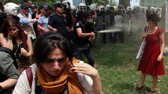 A Turkish riot policeman uses tear gas in Taksim Square on May 28.