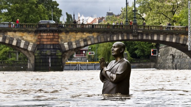 A statue by British sculptor Kaivalya Torpy depicting Indian spiritual leader Sri Chinmoy is partially submerged by the rising waters of the Vltava River on June 2 in downtown Prague.