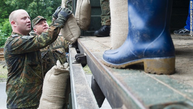 Volunteers and soldiers stack sandbags on June 4 to strengthen a dam of the rising Saale River on the outskirts in Halle, Germany.