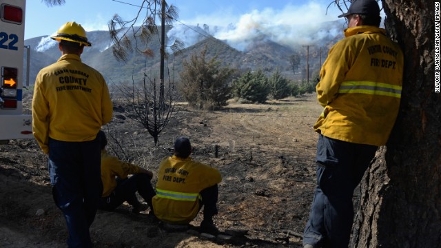 Firefighters watch a hillside burn near Lake Hughes on June 3.