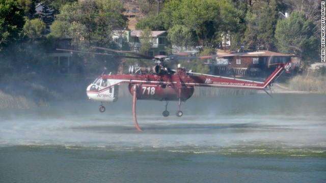 A helicopter fills up from Lake Hughes to battle the Powerhouse wildfire on June 3 in Palmdale.