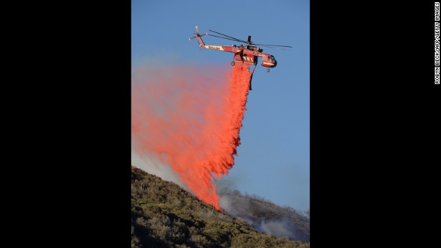 A firefighting helicopter drops fire retardant on a flareup on June 3.