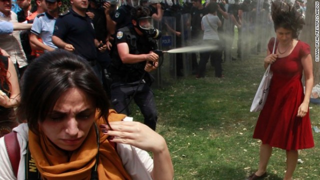 Turkish riot police spray a woman in Taksim Square with pepper spray on May 28, 2013. The <a href='http://www.cnn.com/2013/06/05/world/meast/turkey-woman-in-red/index.html'>woman in a red dress</a> became an icon of the violent protests in Turkey, making international headlines and spreading across social media.