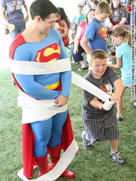 Sometimes superduties just involve spreading a little cheer. Resident Superman Josh Boultinghouse takes part in one of the free games for kids held during the Superman Celebration. 