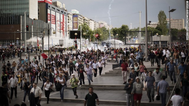 Demonstrators run for cover as police use water cannons and tear gas on the crowd in Ankara on June 5.