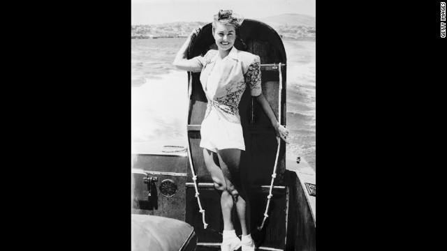 Williams poses with a ironing board before competing in the "Ironing board derby" between Catalina Island and the California coast on August 25, 1947.