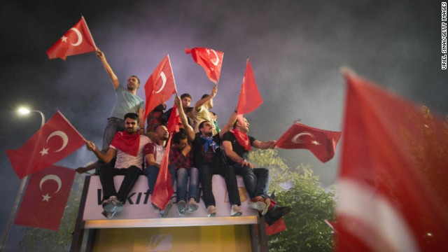 Supporters of Erdogan wave the Turkish flag upon the prime minister's arrival in Istanbul, on June 7.