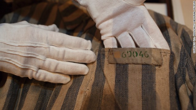 U.S. Holocaust Memorial Museum textile conservator Cynthia Hughes carefully handles a concentration camp uniform that had been worn by a Holocaust survivor. The museum embarked on a national tour this year to commemorate its 20th anniversary. Curators were on hand to review and collect artifacts.