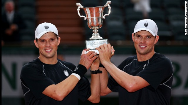  Bob Bryan and Mike Bryan pose with the trophy after winning the men's doubles final against Michael Llorda and Nicolas Mahut of France on June 8. The twins won 6-4, 4-6, 7-6(4).