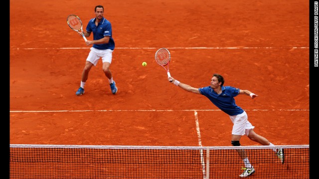 Mahut plays a forehand as his partner Llorda stands ready in the men's doubles final match.