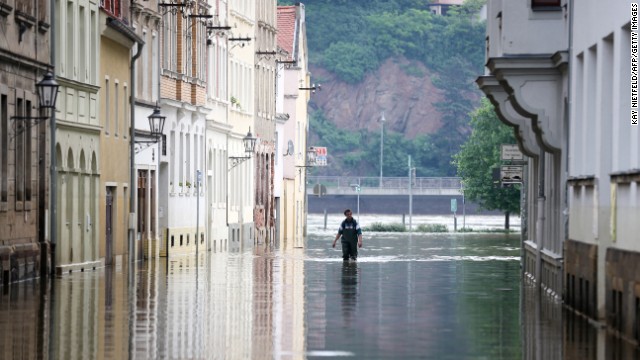 A man walks in high water from the Elbe River in Meissen, Germany, on Sunday, June 9. 