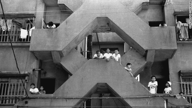 Archive photograph from the 1960s shows children playing in the stairways of the apartment blocks. At that time the population density on the island was among the highest in the world.