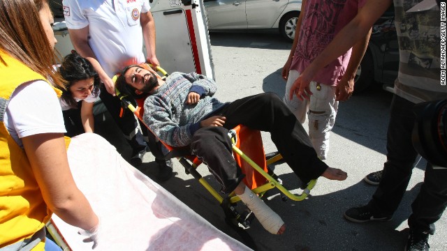 Medics carry Yasin Ayhan, 23, a protester who broke his leg in a raid early Monday, June 10, in Kugulu Park. Riot police doused thousands of protesters in Ankara with tear gas and jets of water for a second straight night. 