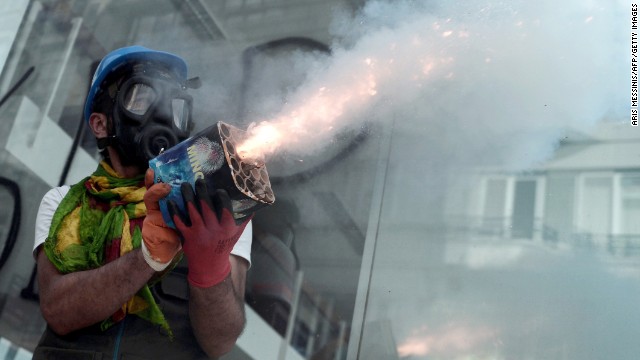 A protester holds fireworks during clashes with riot police in Istabul on June 11.