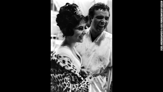  Elizabeth Taylor and Richard Burton share a laugh on the set of 'Cleopatra', Rome, 1962.