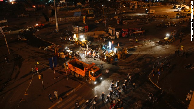 Municipal workers clean up a street in Taksim Square early on June 12, after police moved in to disperse protesters.